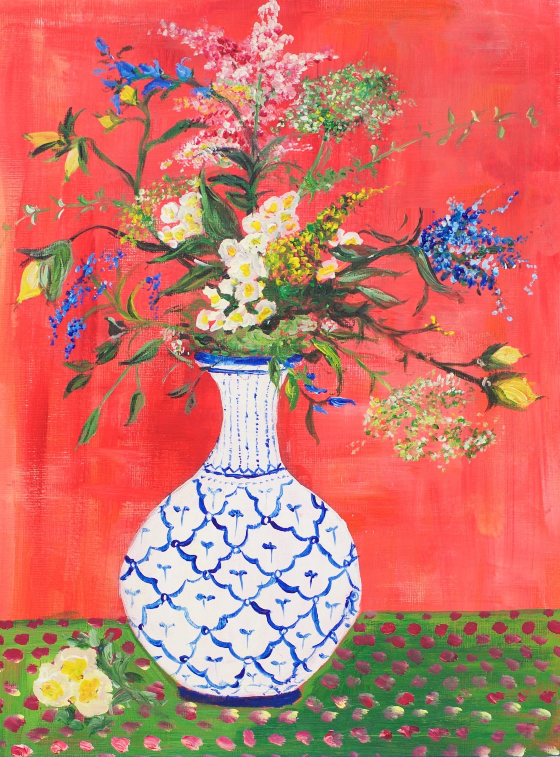 A blue and white vase of flowers on a red backdrop