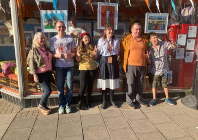 Members of sold studio art group standing outside the front of the shop