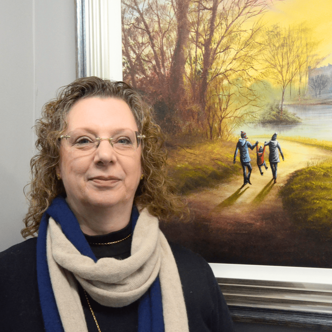 Jane standing in front of a Danny Abrahams painting