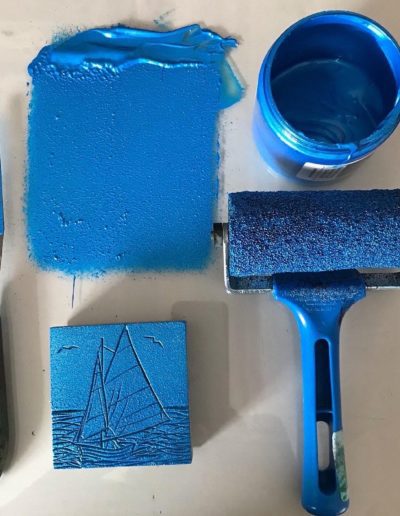 Linoblock tools covered in blue paint