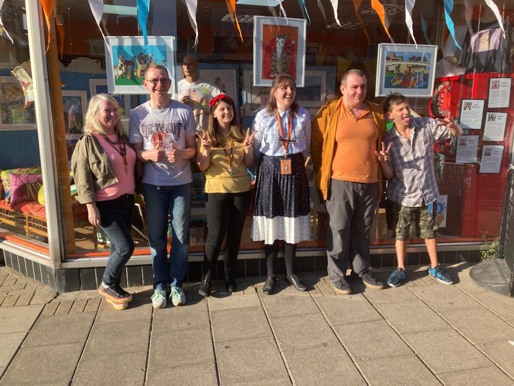 Sold studio art group standing outside the front of sold in shoreham