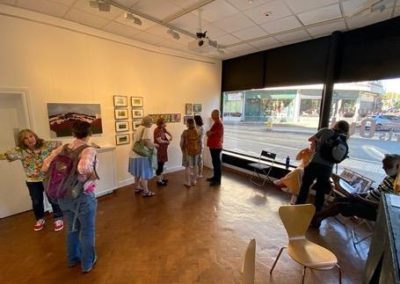 Inside Colonnade House, the gallery is full with people looking at Figment Arts exhibition