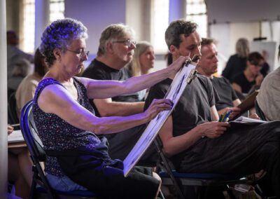 A photograph of participants drawing at the life drawing event as part of creative commissions 2023