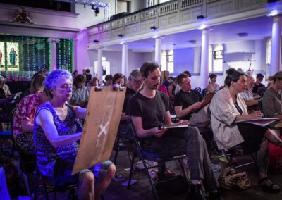 A photograph of participants drawing at the life drawing event as part of creative commissions 2023