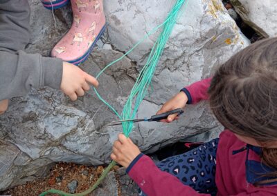 a photograph of children finding rubbish on the beach for the project