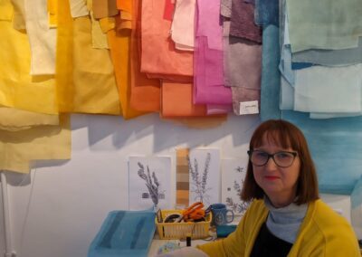 Sara Cook in her pop up studio at Colonnade House with her work in progress fabrics